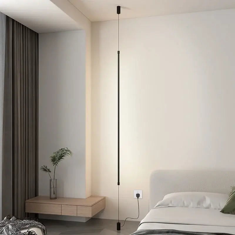 Minimalist black vertical pendant light with sleek, modern design.