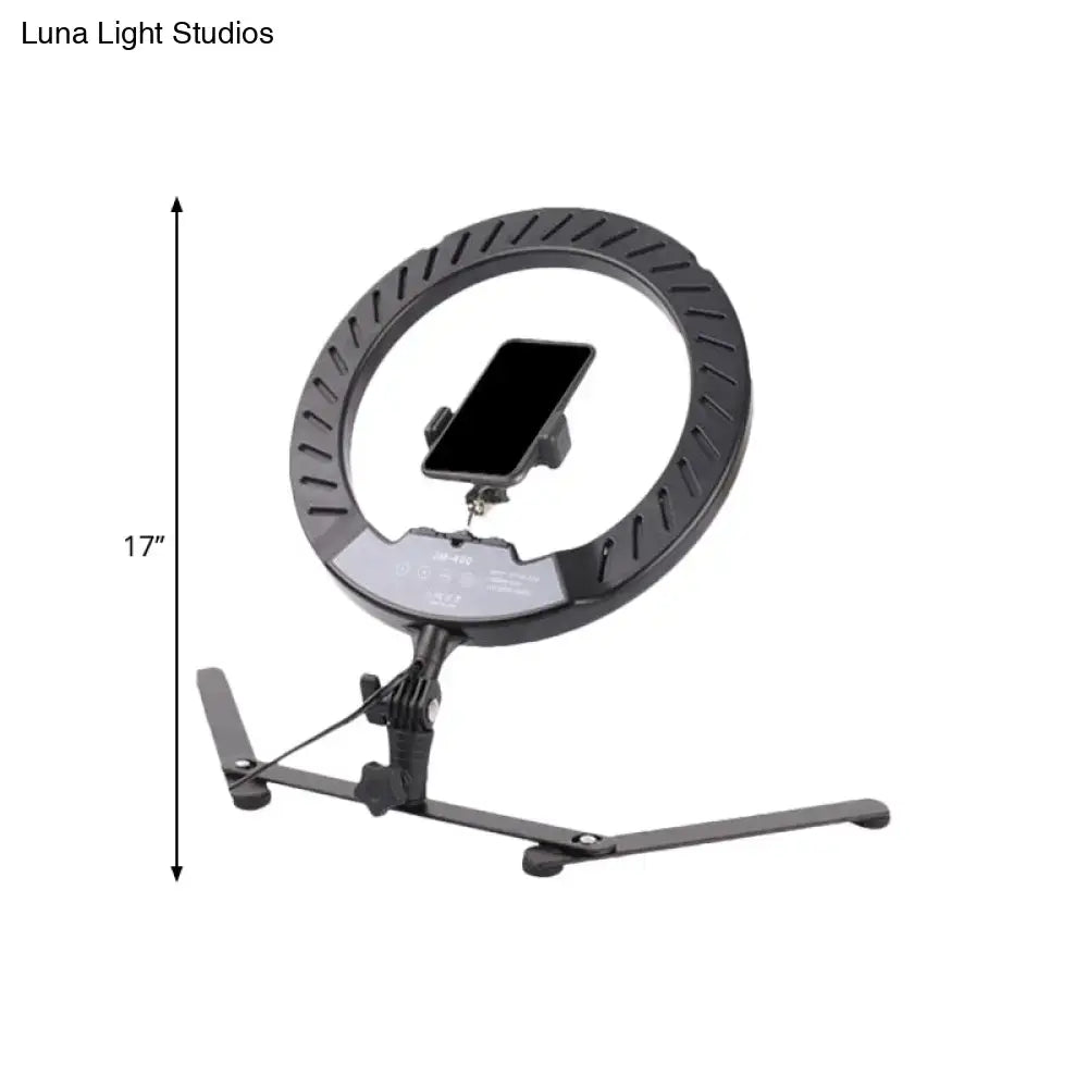 Modern black led ring flash lamp with metallic shade and phone mount on adjustable stand for bedroom lighting