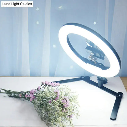 Modern black led ring flash lamp with metallic shade and adjustable stand featuring bright white bulb included illumination