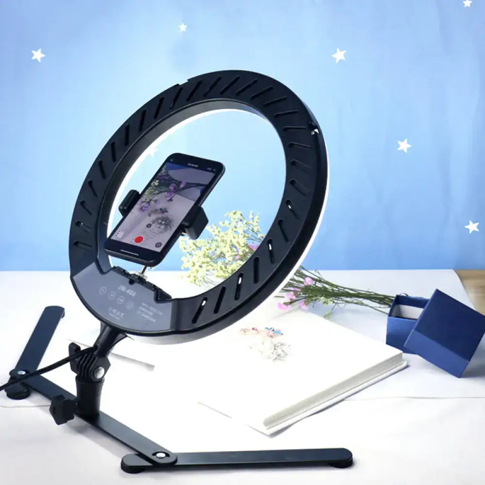 Modern black led ring flash lamp with metallic shade featuring adjustable stand and phone mount for photography lighting