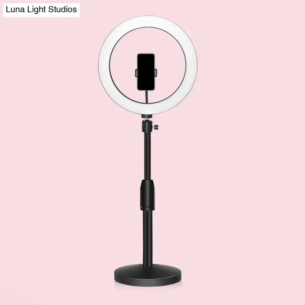 A modern black led ring flash light with adjustable stand and circular halo designed as a versatile wall light