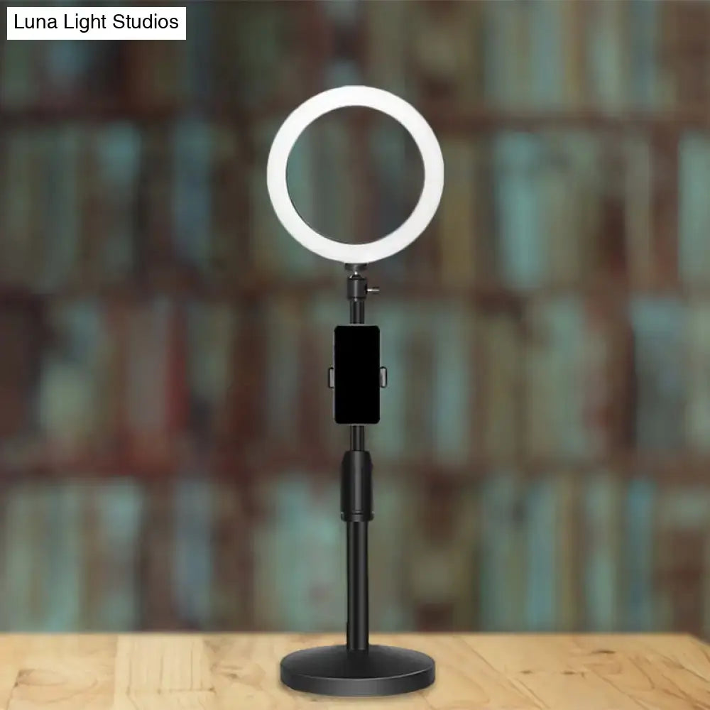 Modern black led ring flash light with adjustable stand and phone holder used as bedroom wall light