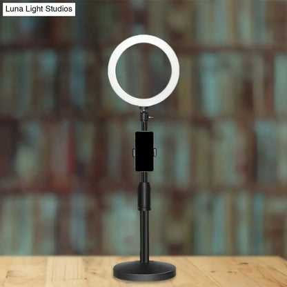 Modern black led ring flash light with adjustable stand and phone holder used as bedroom wall light