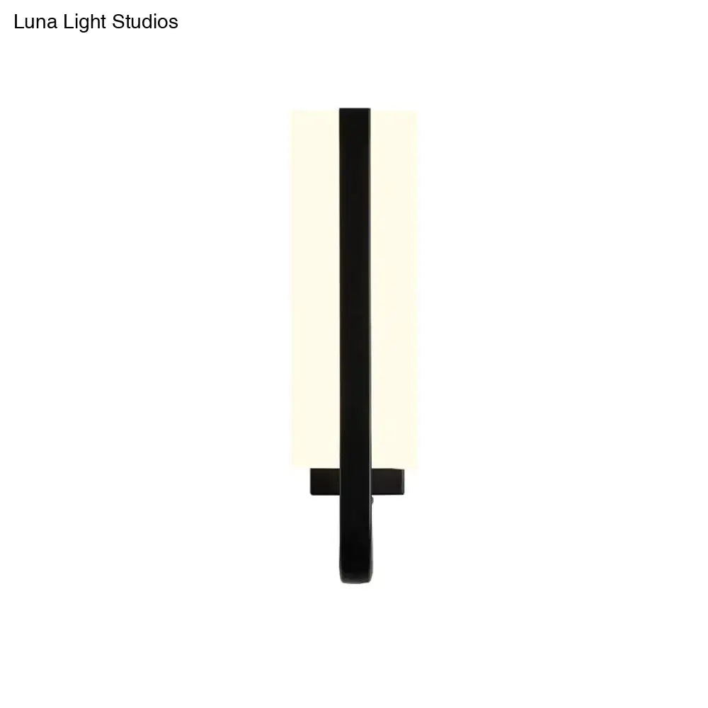 Minimalist black sconce light fixture with sleek vertical design and frosted glass diffuser emitting white warm light