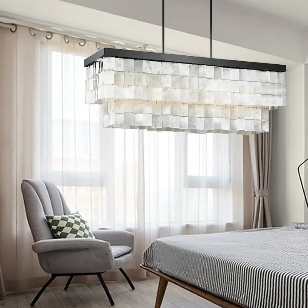 Modern rectangular decorbites™ island light fixture with layered translucent glass panels and black metal frame for living room