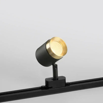 Modern black led track spotlight with a gold circular head and matte black base for kitchen rail ceiling lighting