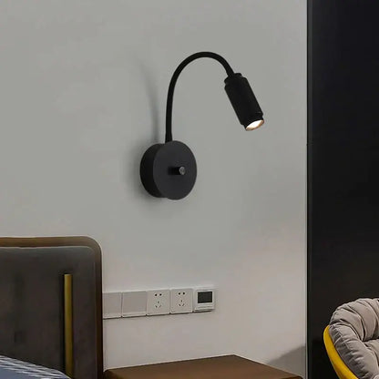 Modern black led wall lamp with adjustable focus and flexible gooseneck arm mounted on the wall for bedroom use