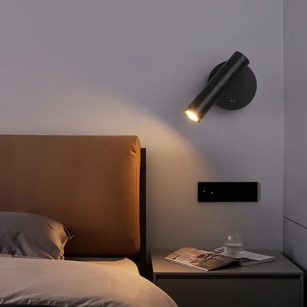 Modern black led wall lamps with adjustable cylindrical design emitting warm glow for bedroom reading light