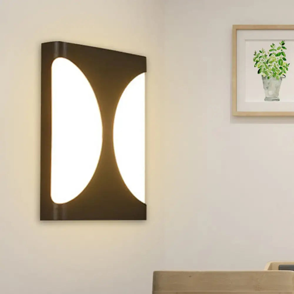 Modern black led wall sconce with double semicircle pattern featuring two illuminated oval panels for bedroom lighting
