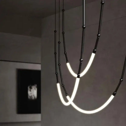 Modern black line chandelier by decorbites leda black features curved glowing led tubes and spherical accents for dining room decor
