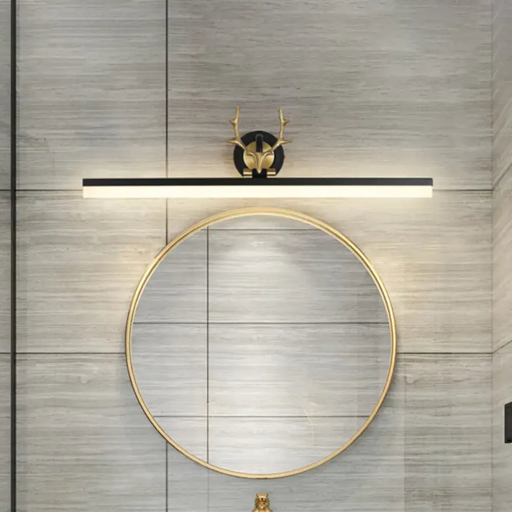 Gold-toned deer-head wall sconce with a black linear light bar vanity light in warm white for bathroom use