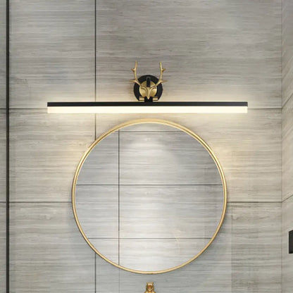 Gold-toned deer-head wall sconce with a black linear light bar vanity light in warm white for bathroom use