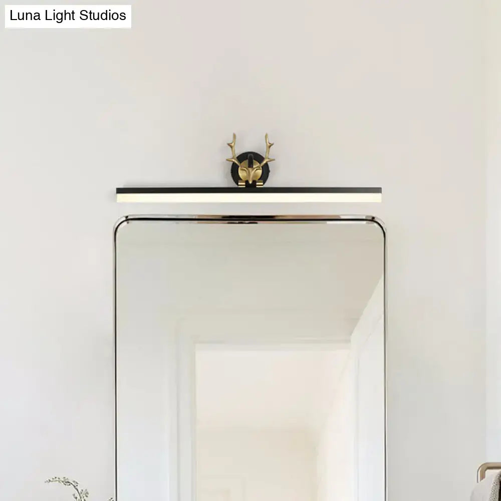 A modern black linear vanity light with warm white LED and a decorative gold deer head accent for bathroom use