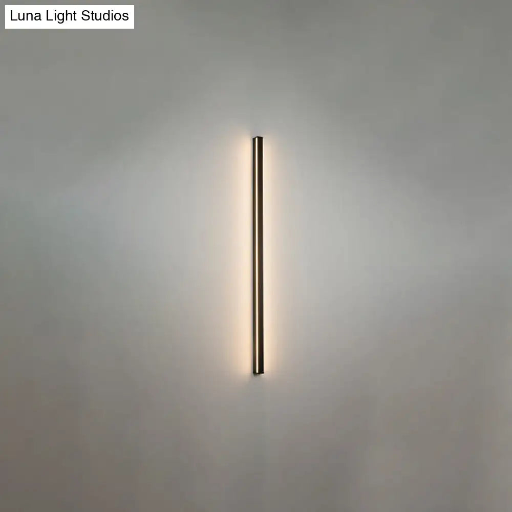 Minimalist modern black linear flush mount wall sconce with an elongated rectangular design emitting warm light