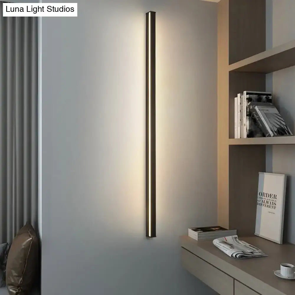 Modern black linear flush mount wall sconce with a sleek slender design providing warm ambient hallway lighting