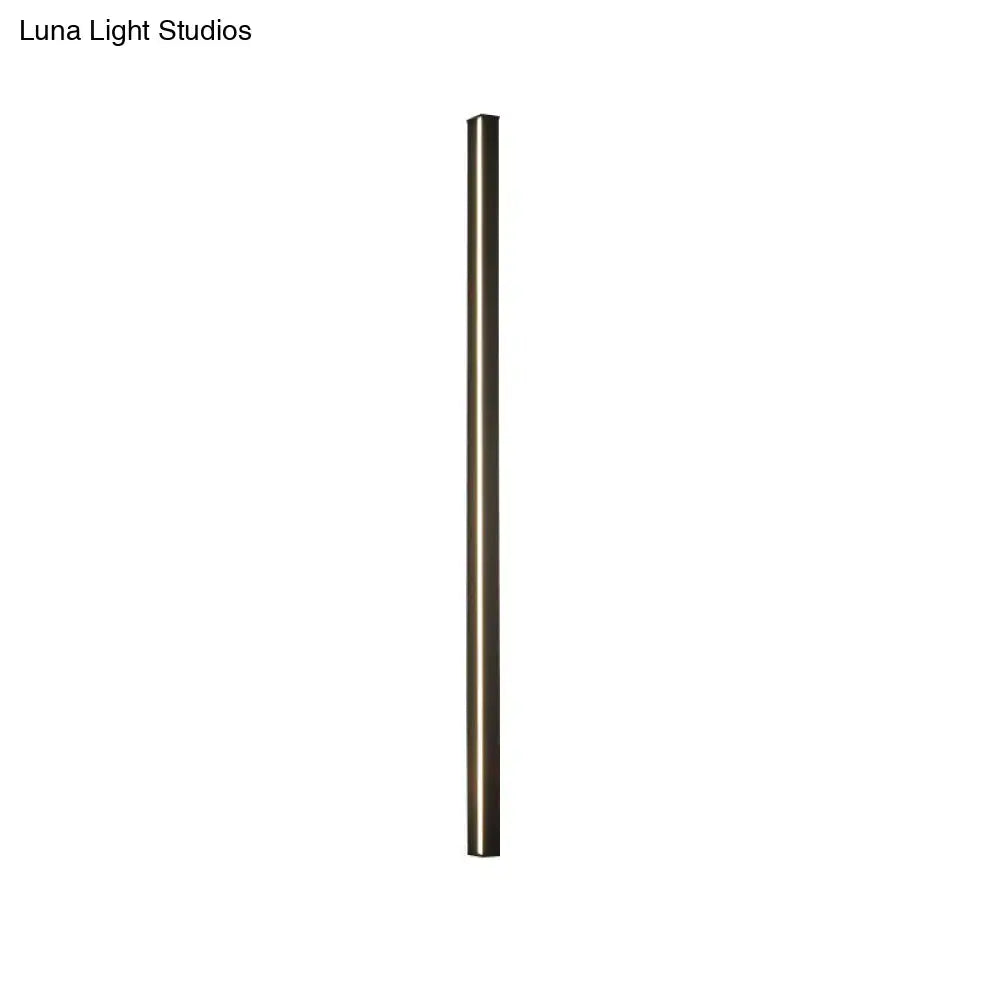 A sleek cylindrical modern floor lamp with matte bronze finish complements a modern black linear flush mount hallway light