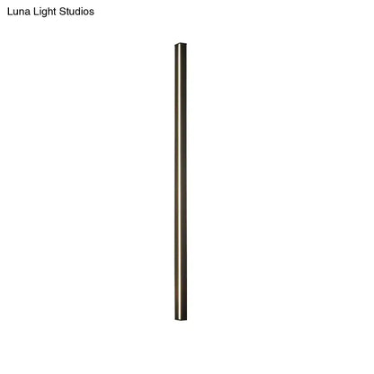 A sleek cylindrical modern floor lamp with matte bronze finish complements a modern black linear flush mount hallway light
