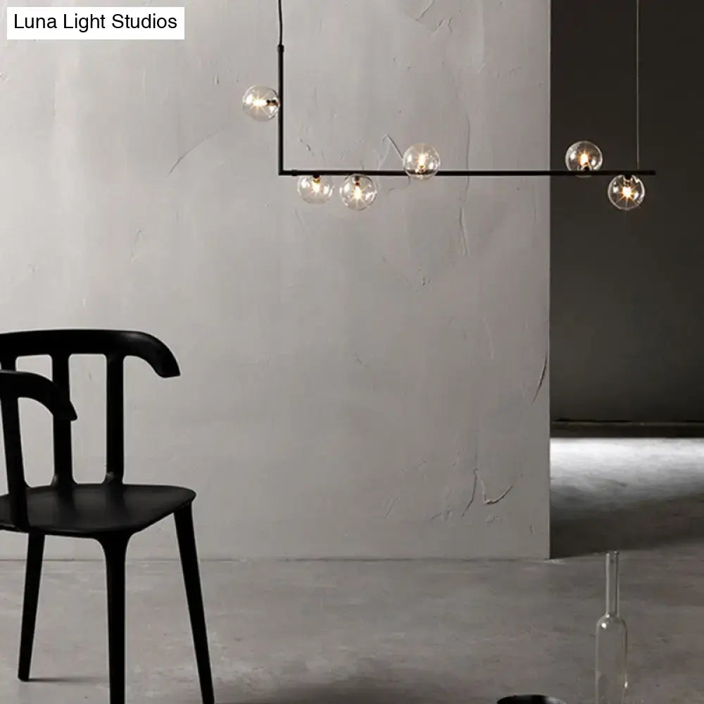 Modern black metal chandelier with five clear glass globe bulbs and glass shade for dining room island pendant lighting