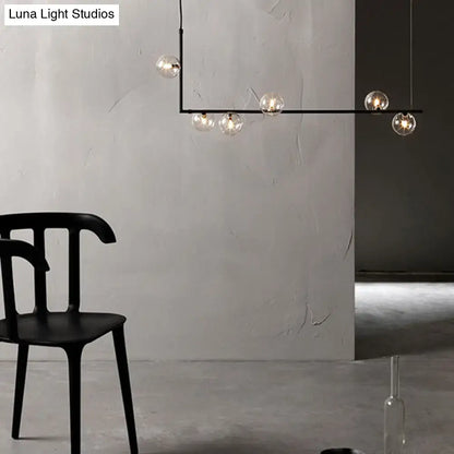 Modern black metal chandelier with five clear glass globe bulbs and glass shade for dining room island pendant lighting