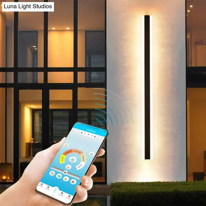Modern black and white linear aluminum wall sconce by DecorBites™ emitting warm light for outdoor use with IP65 rating