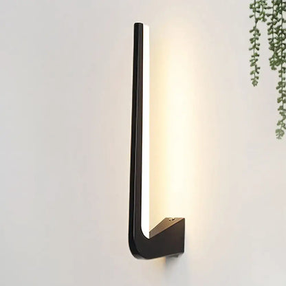 Modern black linear led wall sconce with a sleek minimalist design and warm illuminated strip direct wired electric wall light