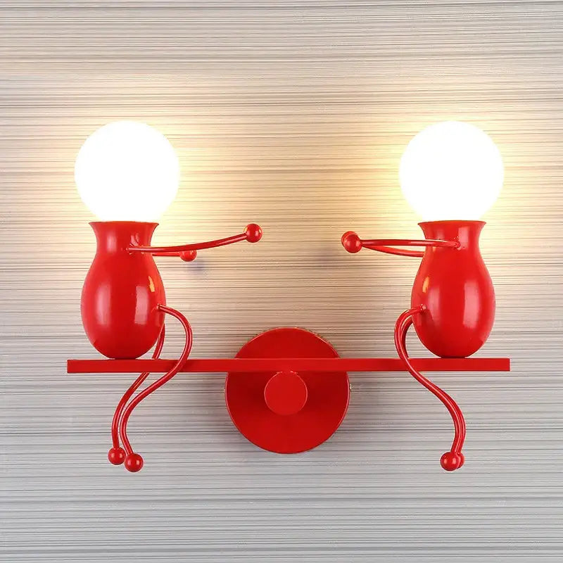 Modern black metallic wall light featuring two whimsical vase-shaped man led wall figures holding glowing bulbs