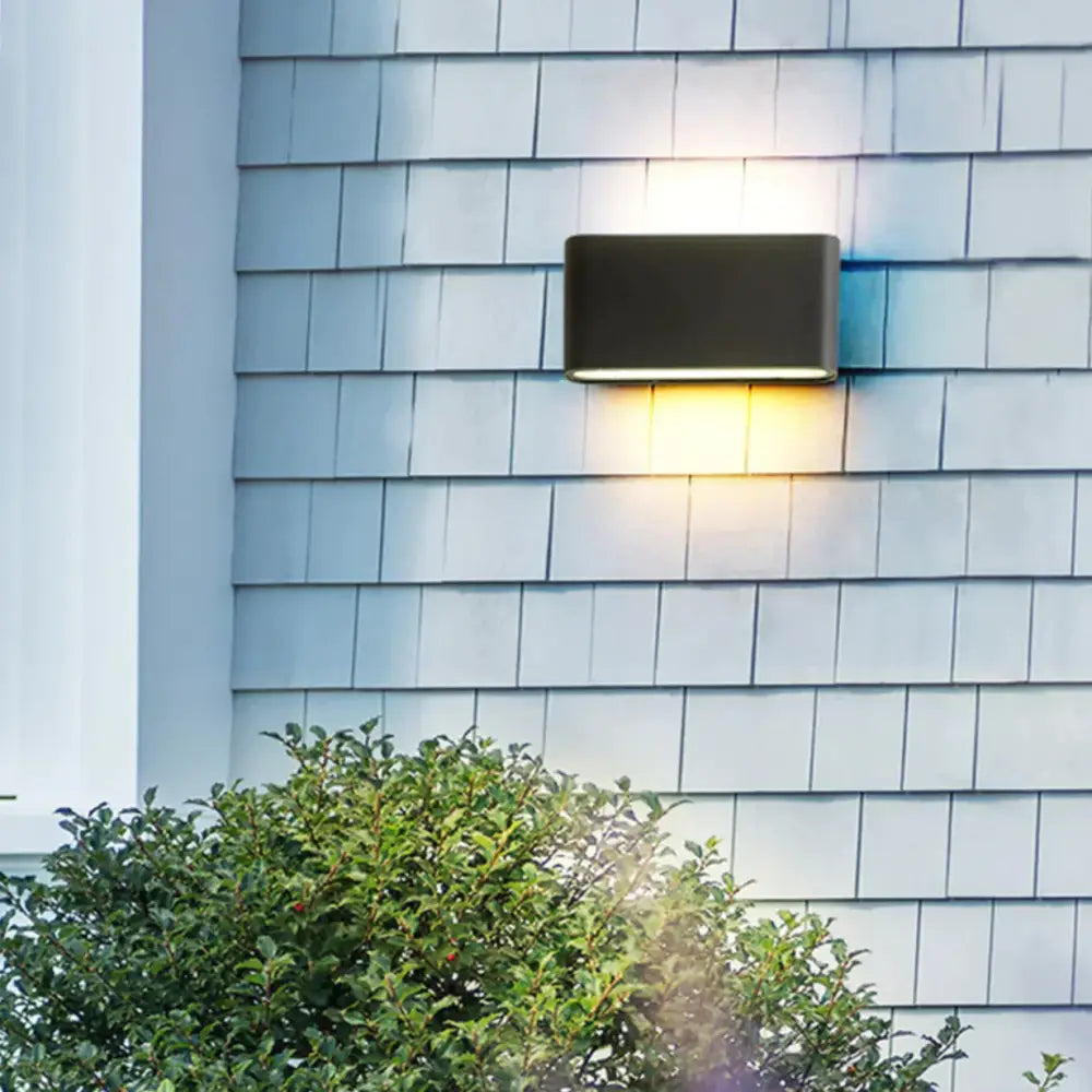 Modern black luna outdoor wall light fixture with rectangular design emitting warm led glow for patio use