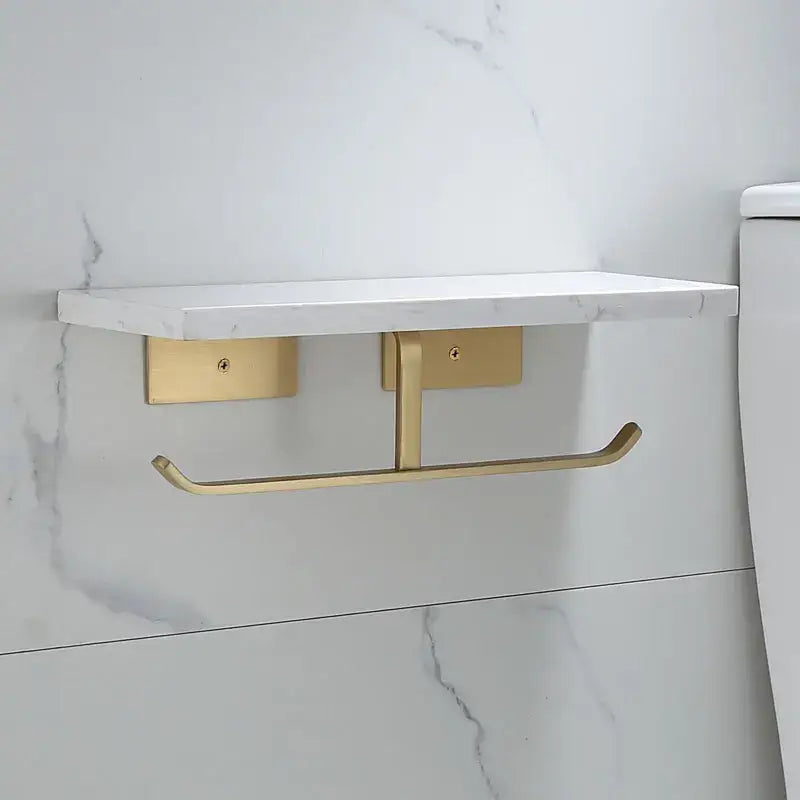 Modern black marble and gold toilet paper holder with a white marble shelf for bathroom storage and organization