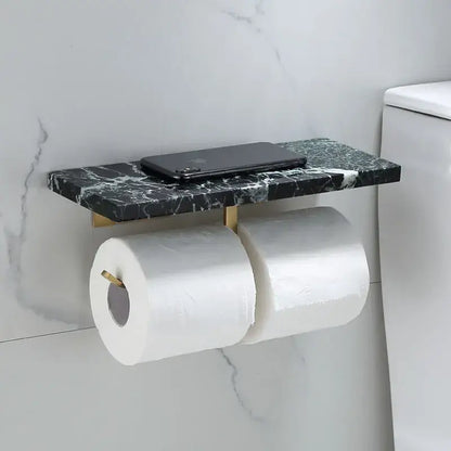Modern black marble and gold toilet paper holder shelf with brackets holding two rolls of toilet paper and smartphone