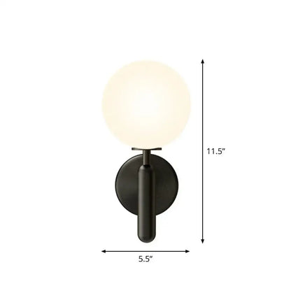 Modern black matte glass globe wall sconce with a black gold accent for stairs lighting featuring a frosted glass globe