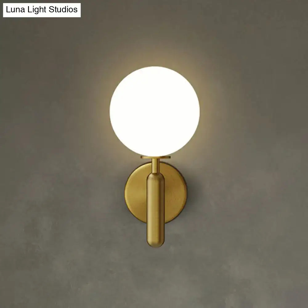 Modern black gold matte wall sconce with frosted glass globe ideal for stairs lighting