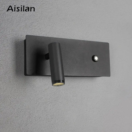 Modern black matte led wall sconce with cylindrical adjustable head and button on rectangular base for bedroom reading light