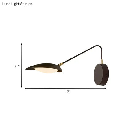 Modern black metal wall lamp with adjustable arm and circular base for bedroom reading mounted on wall
