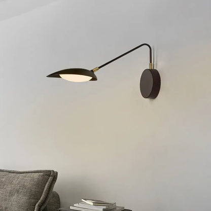 Modern black metal wall lamp with adjustable arm and leaf-shaped shade for bedroom reading use