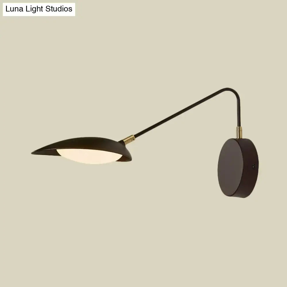 Modern black metal wall lamp with adjustable arm and matte finish designed for bedroom reading use