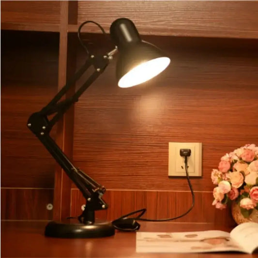 Modern black metal desk lamp with adjustable swing arm and illuminated shade for bedroom or office use
