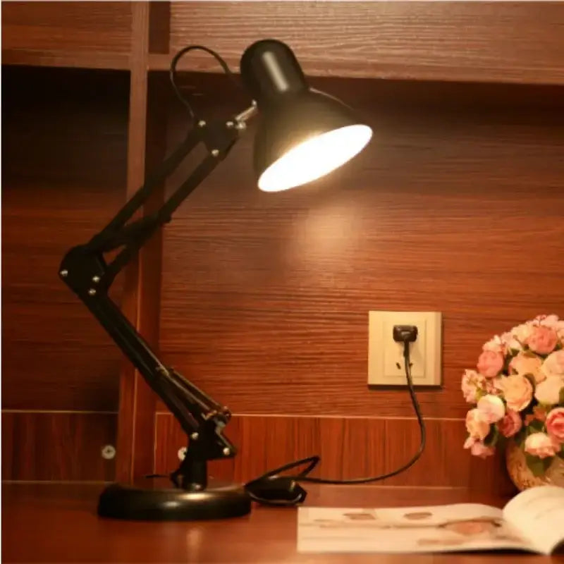 Modern black metal desk lamp with adjustable swing arm and illuminated shade for bedroom or office use