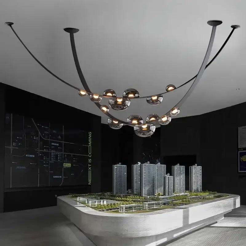 Modern black metal chandelier pendant light with curved arms and globe glass lights for decorbites designer leather loft