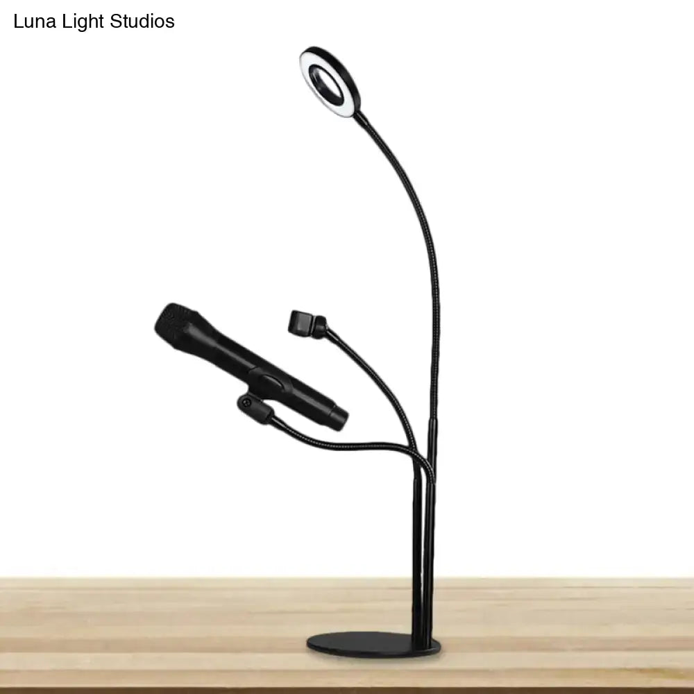 Modern black metal circular vanity light with black flexible gooseneck lamp and two adjustable microphone arms for desk use