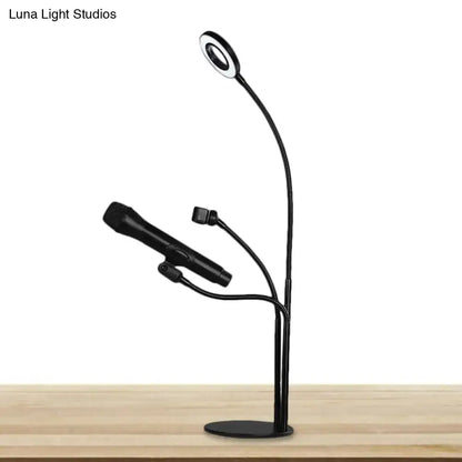 Modern black metal circular vanity light with black flexible gooseneck lamp and two adjustable microphone arms for desk use