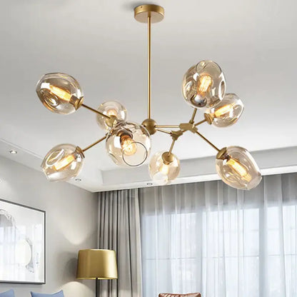 Modern black metal decorbites glass chandelier featuring gold-toned frame with frosted globes for dining room lighting