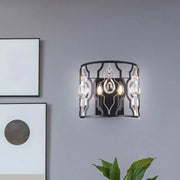 Modern black metal frame wall sconce with crystal droplets and two illuminated bulbs for bedroom lighting