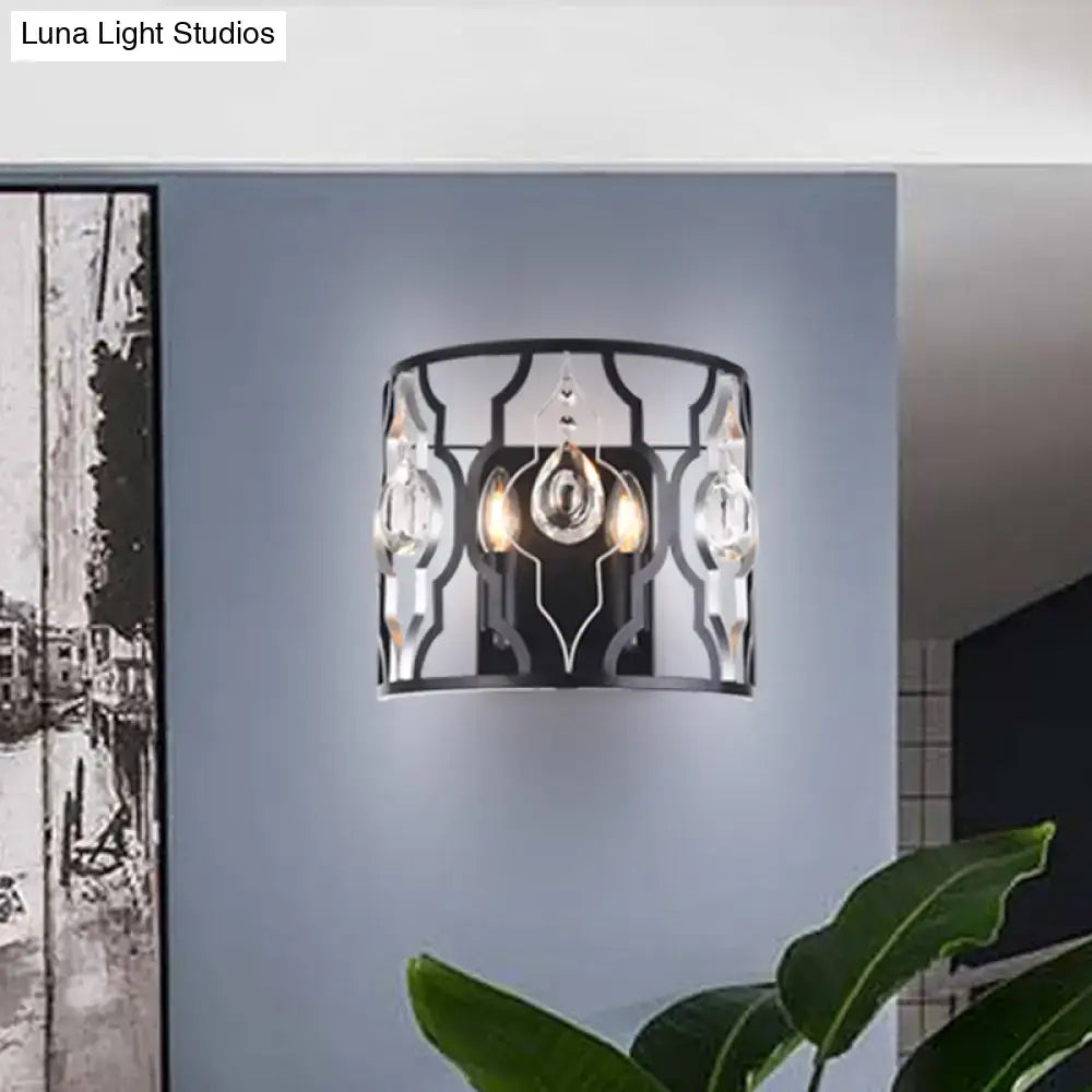 Modern black metal frame wall sconce with crystal droplets and ornate geometric design for bedroom lighting