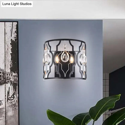 Modern black metal frame wall sconce with crystal droplets and ornate geometric design for bedroom lighting
