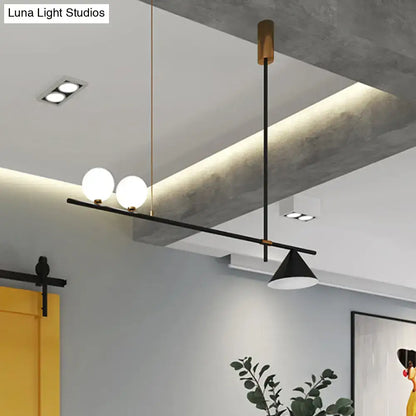 Modern black metal island lamp with opal glass shade featuring three spherical bulbs and a conical pendant light design