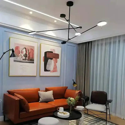 Modern black metal led chandelier with spherical light above orange leather sofa and light gray throw pillows decorbites black metal