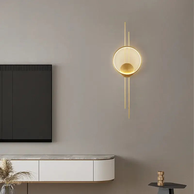 Modern gold-toned wall lights led wall lights with circular illuminated design and slender vertical accents for bedroom decorbites