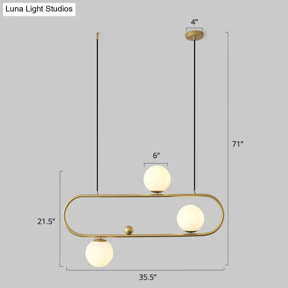 DecorBites™ minimalist metal oblong island light fixture with brass finish and frosted milk glass globes