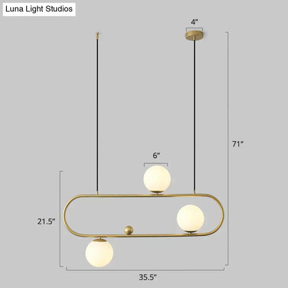 DecorBites™ minimalist metal oblong island light fixture with brass finish and frosted milk glass globes