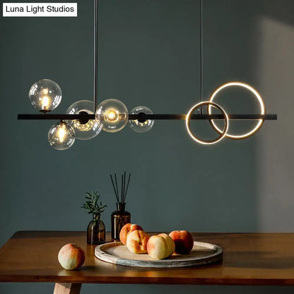 Modern black metal pendant light fixture with glowing circular rings and glass globe bulbs for dining room ceiling light